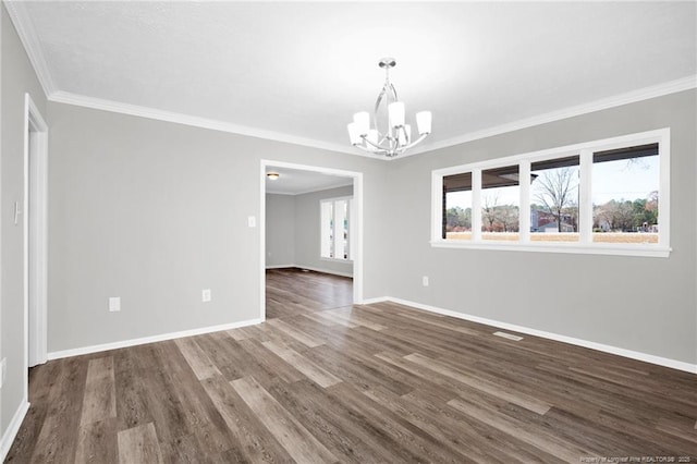 spare room featuring a notable chandelier, dark hardwood / wood-style floors, and crown molding