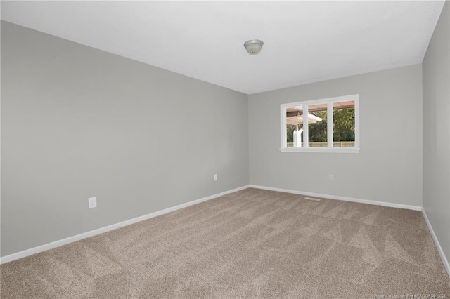 empty room featuring light colored carpet