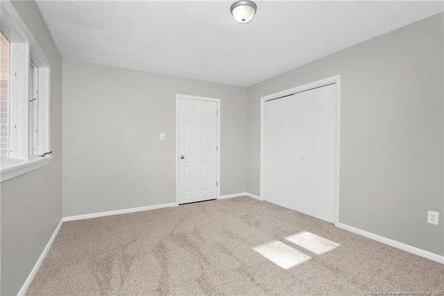 unfurnished bedroom with carpet and a closet