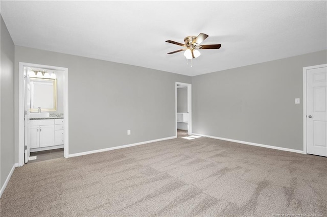 unfurnished bedroom with light carpet, ensuite bath, ceiling fan, and sink