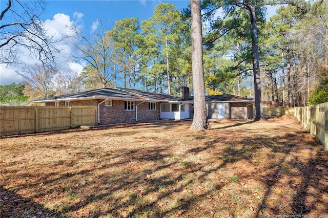 rear view of house with a yard