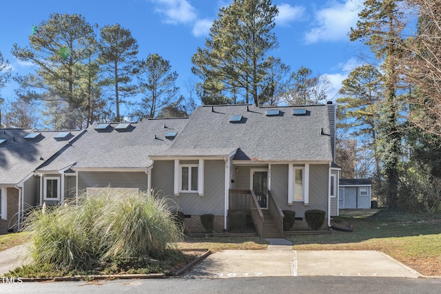 view of front of house featuring a shingled roof and crawl space