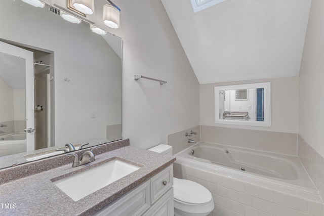 bathroom with vaulted ceiling, a bathing tub, vanity, and toilet