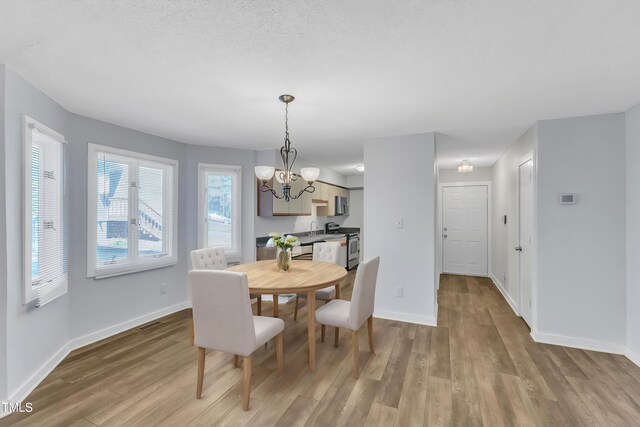 3617 Top Of The Pines Ct, Raleigh, NC 27604 - dining room featuring a chandelier, wood finished floors, and baseboards