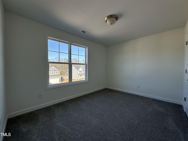 empty room with dark carpet