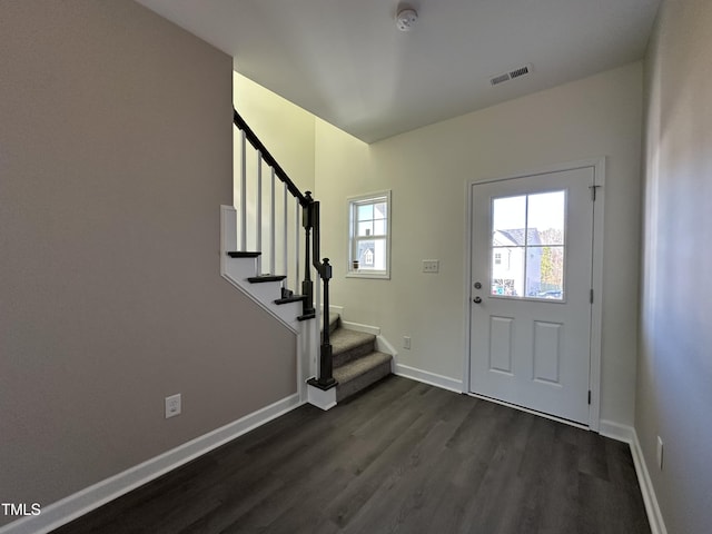 foyer entrance with dark hardwood / wood-style floors