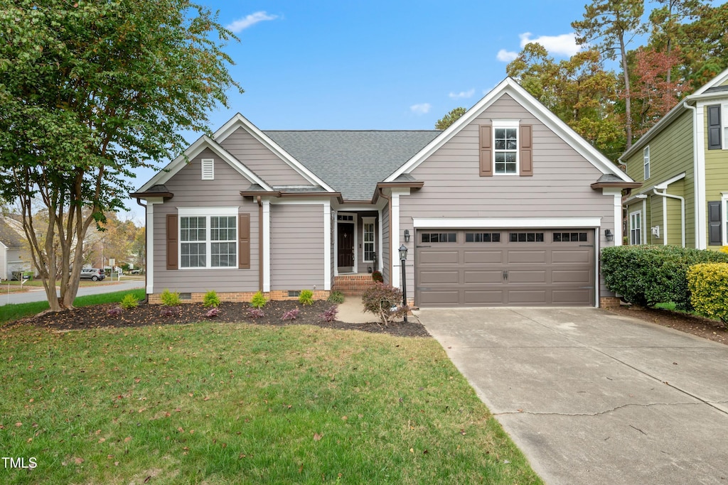 view of front of home featuring a garage and a front yard