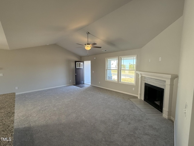 unfurnished living room with ceiling fan, carpet, and vaulted ceiling