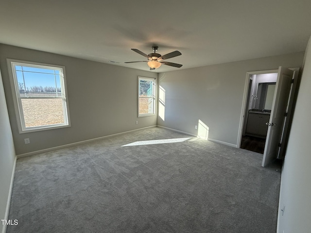 unfurnished bedroom featuring carpet flooring, ensuite bathroom, and ceiling fan