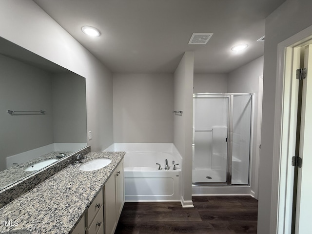 bathroom with hardwood / wood-style flooring, vanity, and independent shower and bath