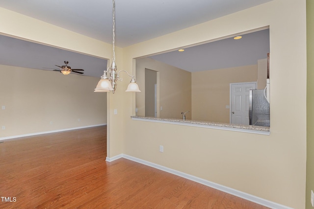 unfurnished room with ceiling fan and wood-type flooring