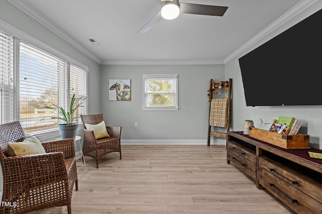 living area with plenty of natural light, ornamental molding, and light wood-type flooring