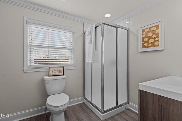 bathroom featuring a shower with shower door, wood-type flooring, ornamental molding, vanity, and toilet