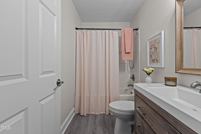 full bathroom featuring vanity, hardwood / wood-style floors, shower / tub combo with curtain, and toilet