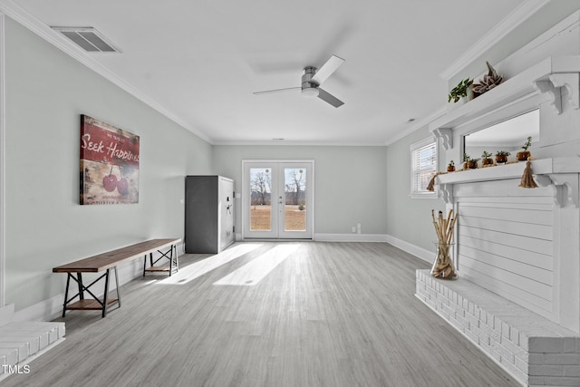 unfurnished living room featuring light hardwood / wood-style flooring, ornamental molding, french doors, and ceiling fan