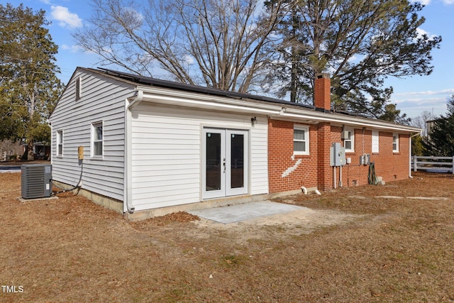 back of property featuring central AC unit and french doors