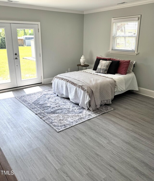5088 Christian Light Rd, Fuquay Varina, NC 27526 - bedroom with baseboards, french doors, wood finished floors, and crown molding