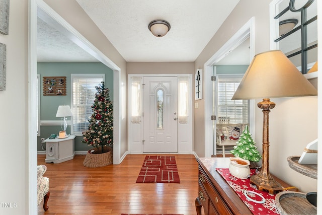 foyer entrance with a textured ceiling and hardwood / wood-style flooring