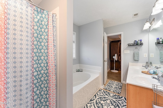 bathroom with tile patterned flooring, vanity, a shower with curtain, and a textured ceiling