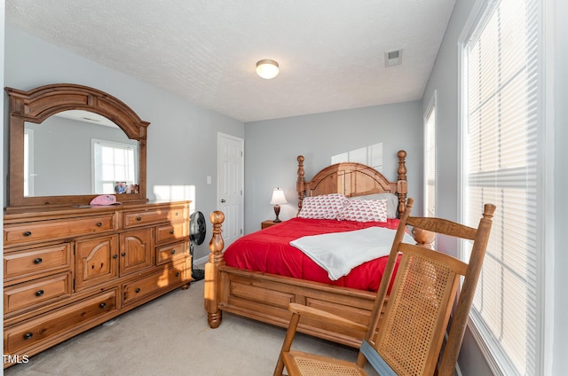 carpeted bedroom with a textured ceiling