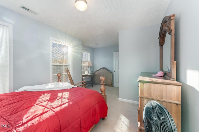 carpeted bedroom with a textured ceiling