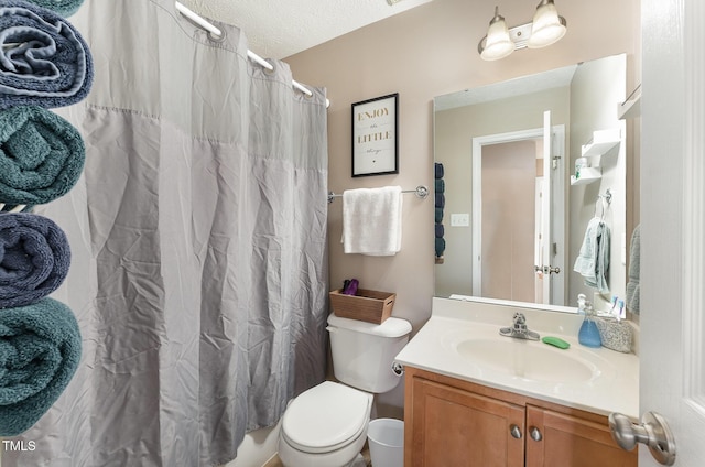 bathroom featuring vanity, toilet, and a textured ceiling