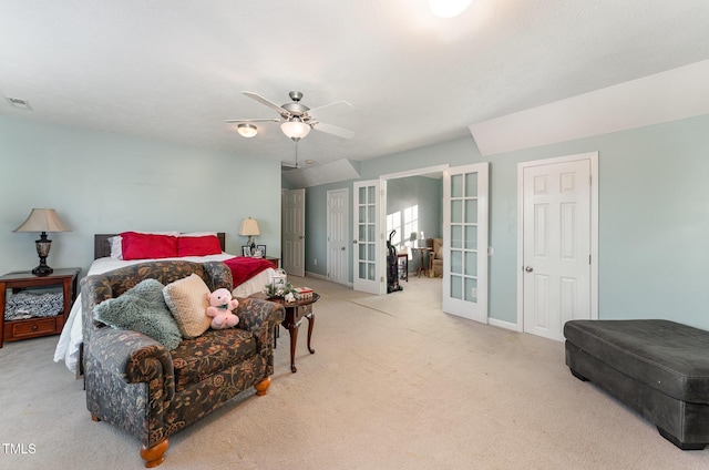 bedroom with ceiling fan, light colored carpet, and french doors