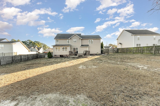 rear view of property featuring a deck