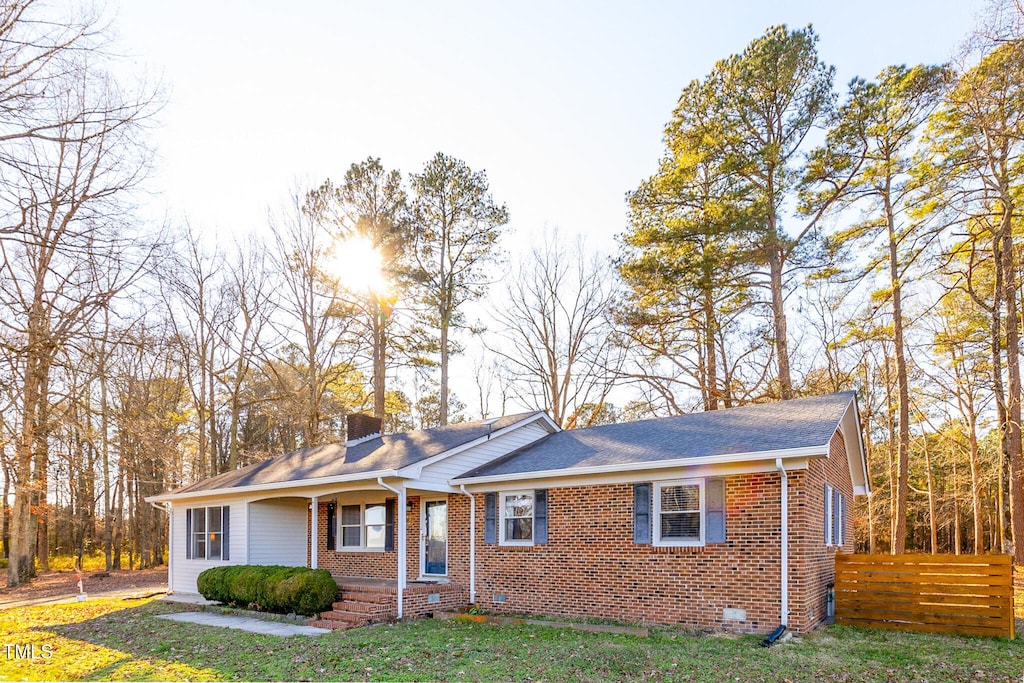 11382 Gaskill Farm Rd, Whitakers, NC 27891 - single story home featuring brick siding, a front lawn, fence, and a chimney