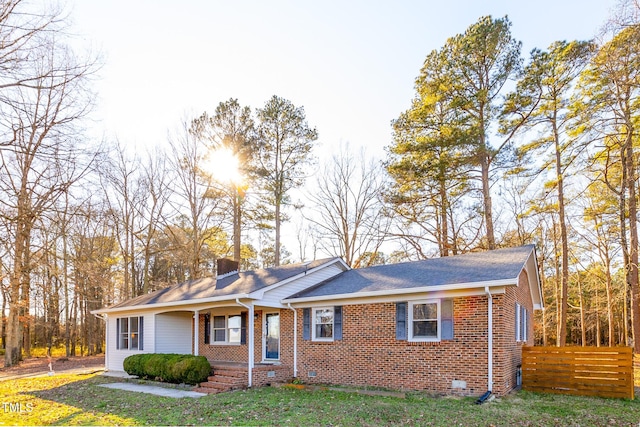 ranch-style home with covered porch and a front lawn