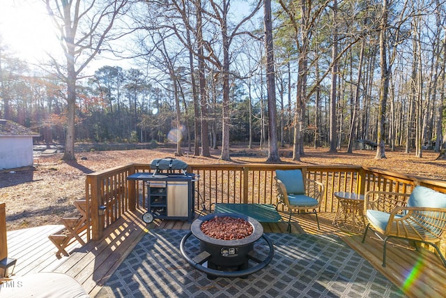 wooden terrace featuring a fire pit