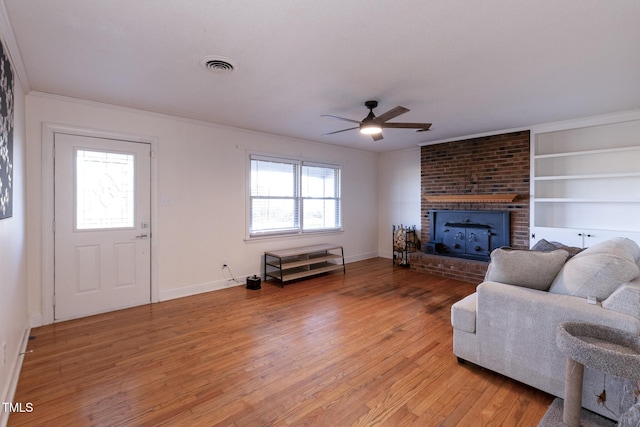 living room with wood-type flooring, built in features, plenty of natural light, and ceiling fan