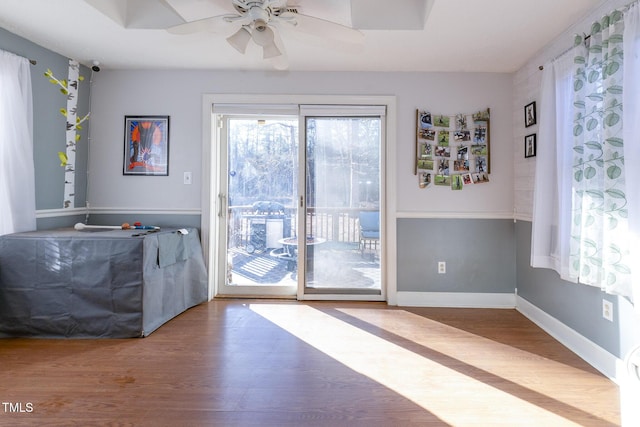 doorway to outside featuring ceiling fan and wood-type flooring