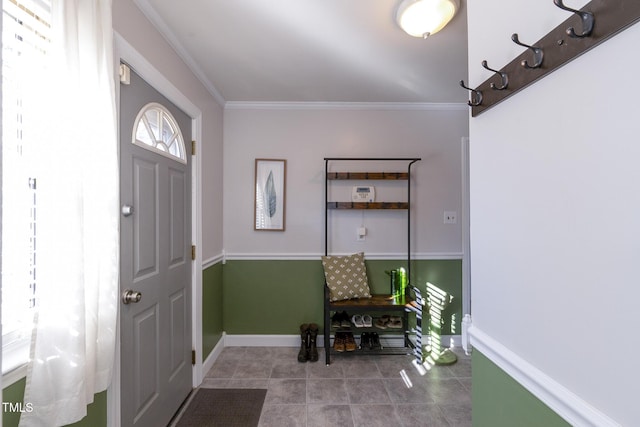 entryway with crown molding and tile patterned flooring