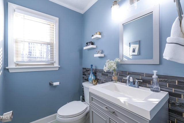 bathroom featuring decorative backsplash, vanity, toilet, and crown molding