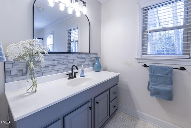 bathroom with decorative backsplash, crown molding, and vanity