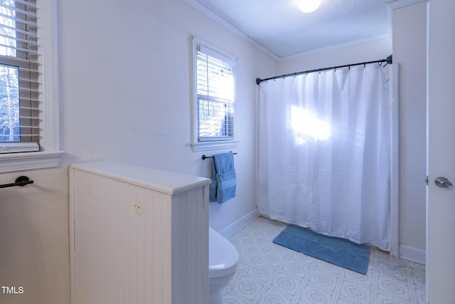 bathroom with toilet and crown molding