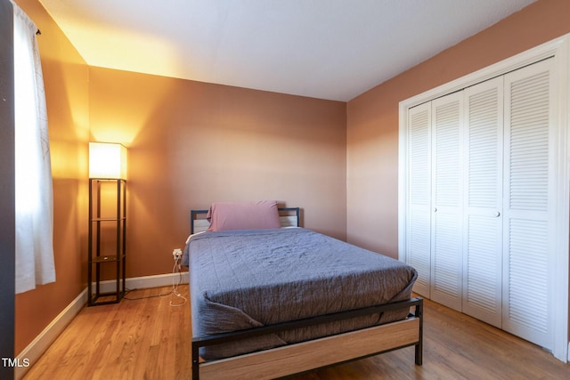 bedroom featuring light hardwood / wood-style flooring and a closet