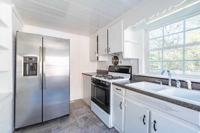 kitchen with white cabinetry, stainless steel fridge, gas range, crown molding, and sink