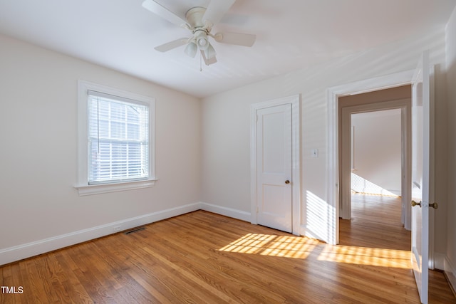 spare room with ceiling fan and light wood-type flooring