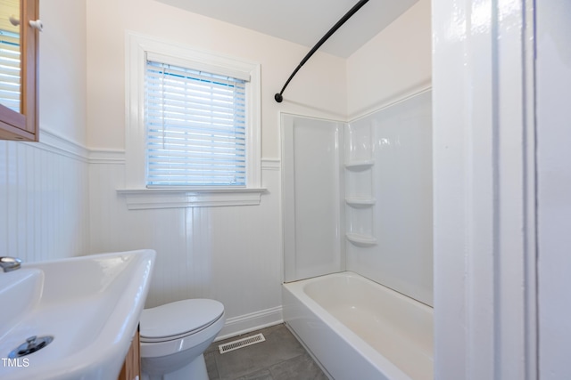 bathroom featuring toilet, tub / shower combination, and tile patterned floors