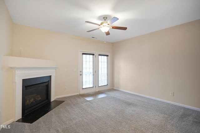 unfurnished living room featuring carpet flooring and ceiling fan