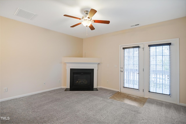 unfurnished living room featuring carpet and ceiling fan