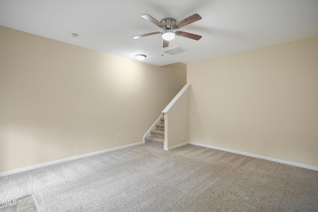 unfurnished room with light colored carpet and ceiling fan