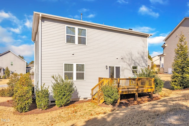 rear view of house with a wooden deck