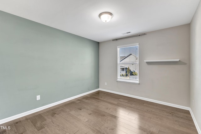 unfurnished room with hardwood / wood-style floors