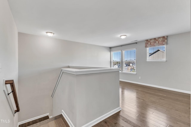 unfurnished room with dark wood-type flooring