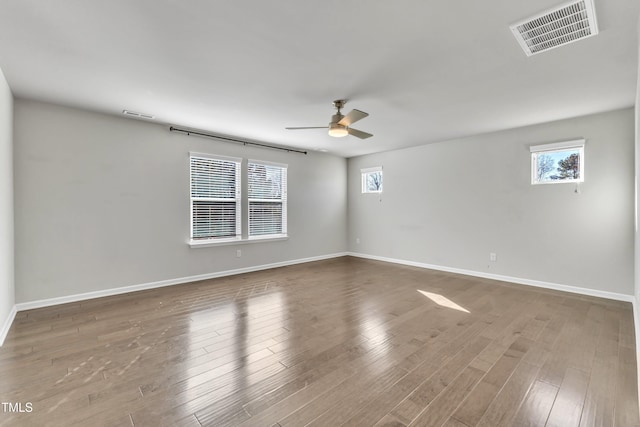 unfurnished room with hardwood / wood-style flooring and ceiling fan