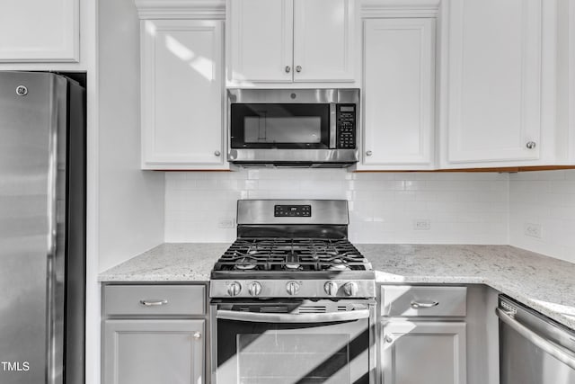 kitchen featuring white cabinets and appliances with stainless steel finishes