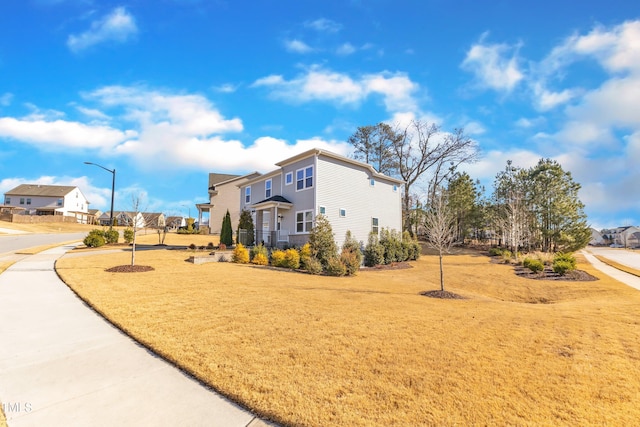 view of side of property with a yard